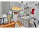 Functional kitchen with white cabinets, tile floors, and stainless steel microwave at 10359 Smyrna Dr, Orlando, FL 32817