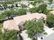 A beautiful aerial view of the property and the community golf course and clubhouse at 10423 Belfry Cir, Orlando, FL 32832