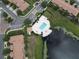 Aerial view of community pool and spa next to the lake at 10423 Belfry Cir, Orlando, FL 32832
