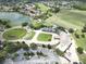 Aerial shot showcasing the golf course, lake, and clubhouse of the surrounding community at 10423 Belfry Cir, Orlando, FL 32832