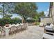 Outdoor patio area with a dining table, hammock, and lounge seating, perfect for entertaining at 10423 Belfry Cir, Orlando, FL 32832