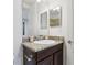 Comfortable bathroom with a granite vanity top, mirror, and well-lit space at 10423 Belfry Cir, Orlando, FL 32832