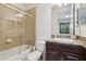 Bathroom featuring a tub and shower combination enclosed with glass, along with a vanity at 10423 Belfry Cir, Orlando, FL 32832