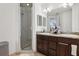 Bathroom featuring a double sink vanity with granite countertop and a glass-enclosed shower at 10423 Belfry Cir, Orlando, FL 32832