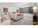 Bright bedroom with a large window, an upholstered bed and accent chair, and a modern vibe at 10423 Belfry Cir, Orlando, FL 32832
