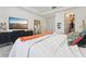 Inviting bedroom with a large dresser, a mirror, and en-suite bathroom and walk-in closet at 10423 Belfry Cir, Orlando, FL 32832