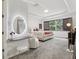 Sunlit bedroom with stylish vanity, upholstered headboard and dark wood shutters at 10423 Belfry Cir, Orlando, FL 32832