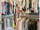 Walk-in closet featuring clothing racks and shelves for storage, with a diverse array of garments at 10423 Belfry Cir, Orlando, FL 32832
