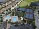 Aerial view of community amenities including pools, tennis courts, basketball courts, and clubhouse at 10423 Belfry Cir, Orlando, FL 32832