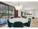 Bright dining room with a round table, seating for six, and sliding doors leading to an outdoor patio at 10423 Belfry Cir, Orlando, FL 32832