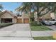 Elegant townhome featuring a stone facade, private balconies, two-car garage and a brick paved driveway at 10423 Belfry Cir, Orlando, FL 32832