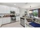Stylish kitchen with stainless steel appliances, granite countertops, and access to a dining area with natural light at 10423 Belfry Cir, Orlando, FL 32832
