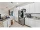 Bright, modern kitchen with stainless steel refrigerator and granite counters and lots of cabinet space at 10423 Belfry Cir, Orlando, FL 32832