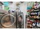 Functional laundry room with modern washer and dryer, along with shelving and shoe storage at 10423 Belfry Cir, Orlando, FL 32832