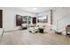 Bright living room with ample natural light, featuring wood flooring, a decorative wall unit, and modern furniture at 10423 Belfry Cir, Orlando, FL 32832