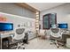 Modern office space featuring dual workstations, decorative wall paneling and an abundance of natural light at 10423 Belfry Cir, Orlando, FL 32832