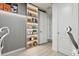 Office detail featuring custom shelving with decorative lighting, adjacent to an open doorway at 10423 Belfry Cir, Orlando, FL 32832