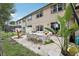 A spacious outdoor patio features an outdoor dining table, furniture, hammock, grill, and lush landscaping at 10423 Belfry Cir, Orlando, FL 32832