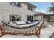 A spacious outdoor patio features an outdoor dining table, furniture, hammock, grill, and string lights at 10423 Belfry Cir, Orlando, FL 32832