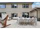 A spacious outdoor patio features an outdoor dining table, furniture, hammock, grill, and string lights at 10423 Belfry Cir, Orlando, FL 32832