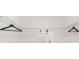 White closet with metal shelving and two white robes at 1184 Alstonia Ln, Mount Dora, FL 32757