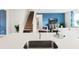 Open living area with a view of the staircase, sink and bright blue accent wall with TV at 1188 Alstonia Ln, Mount Dora, FL 32757