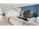 Open-concept living space with a modern sofa and stylish decor and hardwood style floors at 1188 Alstonia Ln, Mount Dora, FL 32757