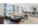 Open-concept living area with comfortable seating, a stylish rug, and modern decor at 1188 Alstonia Ln, Mount Dora, FL 32757