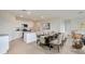 Open-concept dining area featuring a modern table and a full kitchen at 1192 Alstonia Ln, Mount Dora, FL 32757