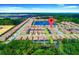 A high-angle aerial view of a residential community surrounded by trees and greenery at 1512 Mumbai Way, Kissimmee, FL 34747