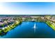 Scenic aerial view of the community, showcasing a picturesque lake and surrounding residential area at 1512 Mumbai Way, Kissimmee, FL 34747