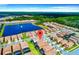 Aerial view showcases a well-planned residential community with a central lake and green spaces at 1512 Mumbai Way, Kissimmee, FL 34747