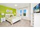 Bright bedroom with vibrant green accent wall, white furniture, and a serene view at 1512 Mumbai Way, Kissimmee, FL 34747