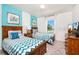 Charming bedroom with two beds, blue accent wall, and natural light from window at 1512 Mumbai Way, Kissimmee, FL 34747