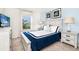 Inviting bedroom with a plush bed, blue accent wall, and a bright window at 1512 Mumbai Way, Kissimmee, FL 34747