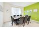 Dining room features a large table, neutral chairs, decor and a large window for lots of light at 1512 Mumbai Way, Kissimmee, FL 34747