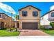 Inviting two-story home with a neatly manicured lawn and a spacious two-car garage at 1512 Mumbai Way, Kissimmee, FL 34747