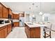 Open concept kitchen with stainless steel appliances, a center island with seating and pendant lighting at 1512 Mumbai Way, Kissimmee, FL 34747
