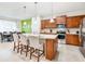Kitchen features stainless steel appliances, shaker cabinets, quartz countertops, and island seating at 1512 Mumbai Way, Kissimmee, FL 34747