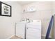 Bright laundry room with modern washer and dryer, practical storage, and stylish decor at 1512 Mumbai Way, Kissimmee, FL 34747