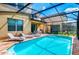 Sparkling pool with lounge chairs in a screened enclosure, perfect for relaxation and enjoying the outdoors at 1512 Mumbai Way, Kissimmee, FL 34747
