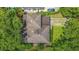 Aerial view of a home featuring a well-maintained roof, driveway, and surrounding greenery at 1606 Orangewood Ave, Orlando, FL 32806