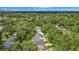 An aerial of the property features mature trees, lush landscaping, and an expansive neighborhood setting at 1606 Orangewood Ave, Orlando, FL 32806