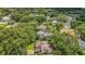 An aerial view shows the property nestled among lush trees in an established neighborhood setting at 1606 Orangewood Ave, Orlando, FL 32806