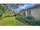 This backyard features a stone table, benches, and lush greenery with natural light shining through at 1606 Orangewood Ave, Orlando, FL 32806