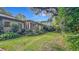 Spacious backyard features lush greenery, a well-maintained lawn, and natural light at 1606 Orangewood Ave, Orlando, FL 32806