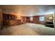 Spacious finished basement with wood paneled walls and a classic bar area at 1606 Orangewood Ave, Orlando, FL 32806