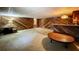 Basement with wood paneled walls, wet bar, and neutral carpet at 1606 Orangewood Ave, Orlando, FL 32806