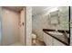 Bathroom featuring a vanity, a toilet, and a shower with patterned wall paper at 1606 Orangewood Ave, Orlando, FL 32806