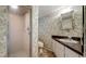 Bathroom featuring a vanity, a toilet, and a shower with patterned wall paper at 1606 Orangewood Ave, Orlando, FL 32806